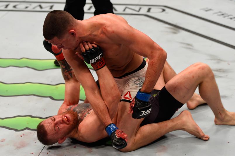 LAS VEGAS, NV - MARCH 05: Nate Diaz (top) punches Conor McGregor of Ireland in their welterweight bout during the UFC 196 event inside MGM Grand Garden Arena on March 5, 2016 in Las Vegas, Nevada. (Photo by Josh Hedges/Zuffa LLC/Zuffa LLC via Getty Images)