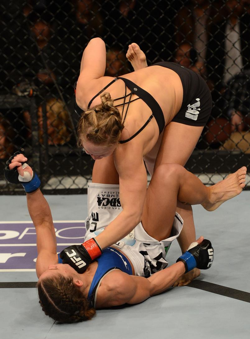 Ronda Rousey punches Liz Carmouche in their women's bantamweight title fight during UFC 157 at Honda Center on February 23, 2013 in Anaheim, CA. (Photo by Donald Miralle/Zuffa LLC)