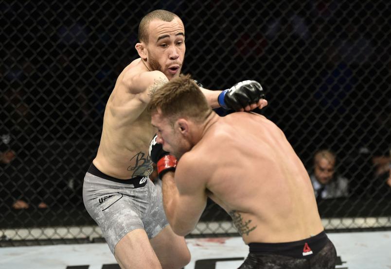 BOSTON, MASSACHUSETTS - OCTOBER 18: (L-R) Sean Woodson punches Kyle Bochniak in their featherweight bout during the UFC Fight Night event at TD Garden on October 18, 2019 in Boston, Massachusetts. (Photo by Chris Unger/Zuffa LLC)