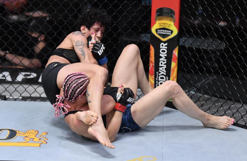 In this handout image provided by UFC, Virna Jandiroba (L) of Brazil secures an arm bar submission against Felice Herrig in their strawweight bout during the UFC 252 event at UFC APEX on August 15, 2020 in Las Vegas, Nevada. (Photo by Jeff Bottari/Zuffa LLC via Getty Images)