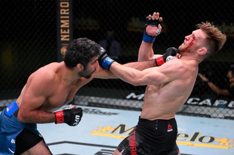 LAS VEGAS, NEVADA - AUGUST 08: (L-R) Beneil Dariush of Iran punches Scott Holtzman in their lightweight fight during the UFC Fight Night event at UFC APEX on August 08, 2020 in Las Vegas, Nevada. (Photo by Chris Unger/Zuffa LLC)