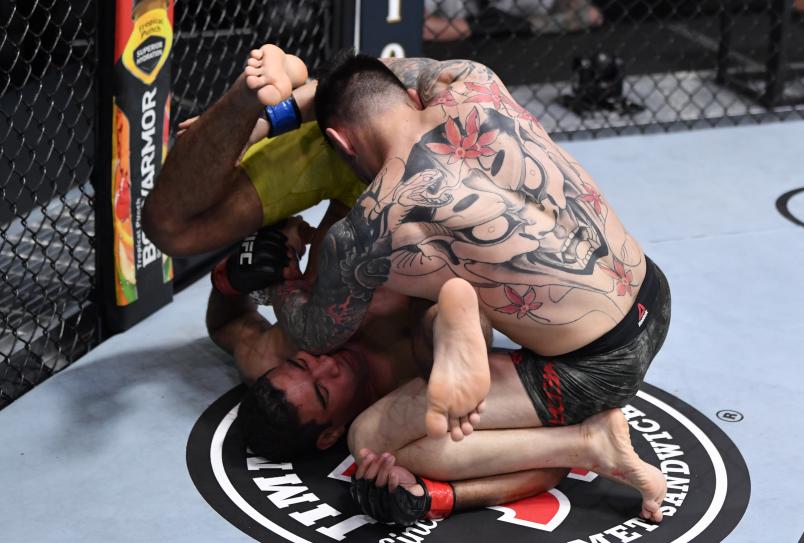 Daniel Pineda punches Herbert Burns of Brazil in their featherweight bout during the UFC 252 event at UFC APEX on August 15, 2020 in Las Vegas, Nevada. (Photo by Jeff Bottari/Zuffa LLC)