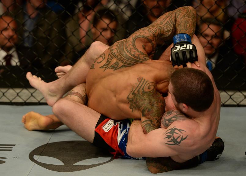  Jim Miller secures a guillotine choke submission against Yancy Medeiros in their lightweight bout during the UFC 172 event at the Baltimore Arena on April 26, 2014 in Baltimore, Maryland. (Photo by Patrick Smith/Zuffa LLC via Getty Images)