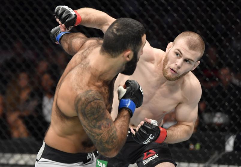 Jake Matthews of Australia punches Rostem Akman of Sweden in their welterweight fight during the UFC 243 event at Marvel Stadium on October 06, 2019 in Melbourne, Australia. (Photo by Jeff Bottari/Zuffa LLC)