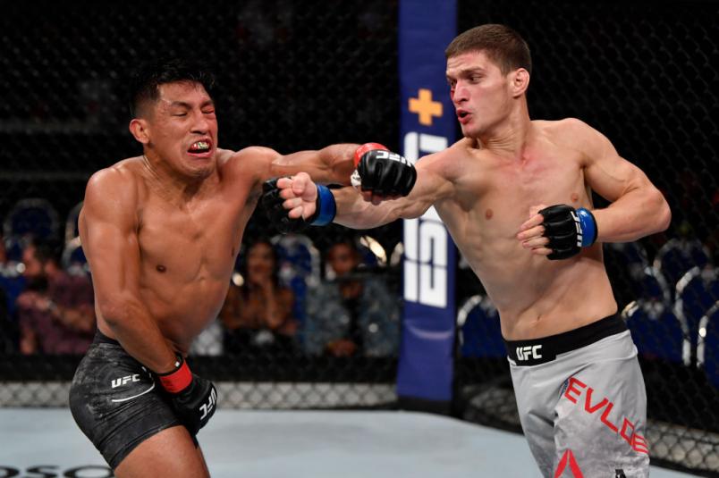 SINGAPORE, SINGAPORE - OCTOBER 26: (R-L) Movsar Evloev of Russia punches Enrique Barzola of Peru in their featherweight bout during the UFC Fight Night event at Singapore Indoor Stadium on October 26, 2019 in Singapore. (Photo by Jeff Bottari/Zuffa LLC)