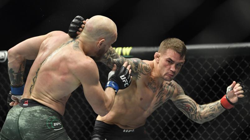 Dustin Poirier punches Conor McGregor of Ireland in a lightweight fight during the UFC 257 event inside Etihad Arena on UFC Fight Island on January 23, 2021 in Abu Dhabi, United Arab Emirates. (Photo by Chris Unger/Zuffa LLC)