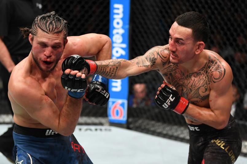 Max Holloway punches Brian Ortega in their UFC featherweight championship fight during the UFC 231 event at Scotiabank Arena on December 8, 2018 in Toronto, Canada. (Photo by Josh Hedges/Zuffa LLC)