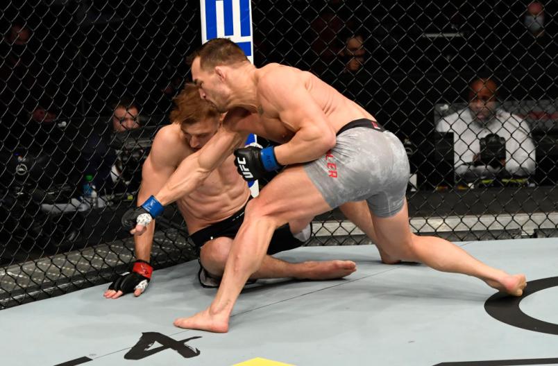 Michael Chandler punches Dan Hooker of New Zealand in a lightweight fight during the UFC 257 event inside Etihad Arena on UFC Fight Island on January 23, 2021 in Abu Dhabi, United Arab Emirates. (Photo by Jeff Bottari/Zuffa LLC)