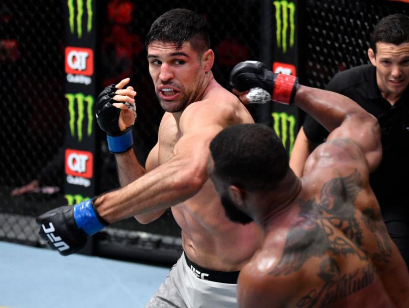 Vicente Luque punches Tyron Woodley in their welterweight fight during the UFC 260 event at UFC APEX on March 27, 2021 in Las Vegas, Nevada. (Photo by Jeff Bottari/Zuffa LLC)