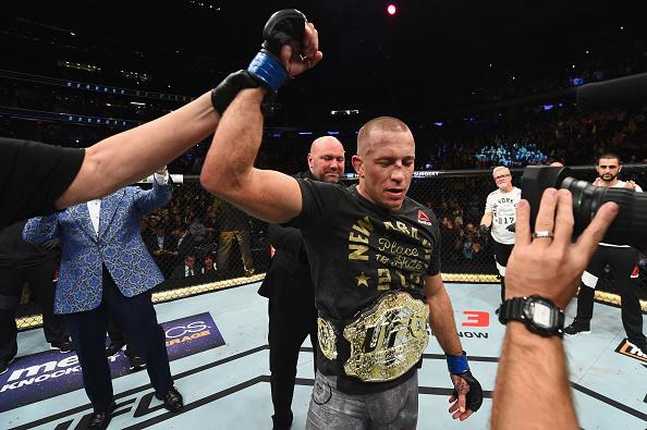 Georges St-Pierre of Canada celebrates with his championship belt after defeating Michael Bisping of England in their UFC middleweight championship bout during the UFC 217 event at Madison Square Garden on November 4, 2017 in New York City. (Photo by Josh Hedges/Zuffa LLC)