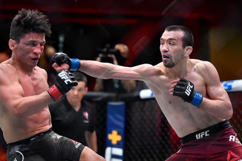 Askar Askaarov of Russia punches Joseph Benavidez in their flyweight fight during the UFC 259 event at UFC APEX on March 06, 2021 in Las Vegas, Nevada. (Photo by Chris Unger/Zuffa LLC)