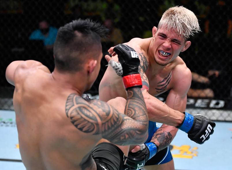 TJ Brown punches Kai Kamaka in a featherweight bout during the UFC Fight Night event at UFC APEX on May 01, 2021 in Las Vegas, Nevada. (Photo by Jeff Bottari/Zuffa LLC)