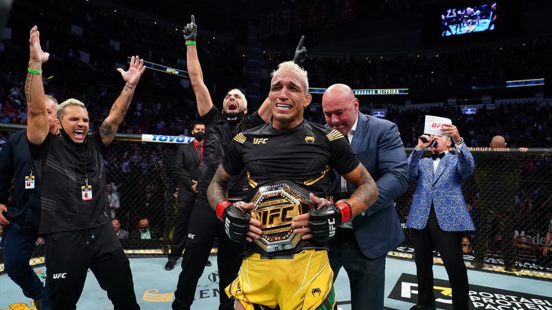 Charles Oliveira of Brazil reacts as UFC President Dana White places the UFC lightweight championship belt around his waist after defeating Michael Chandler at Toyota Center on May 15, 2021 in Houston, Texas. (Photo by Josh Hedges/Zuffa LLC)