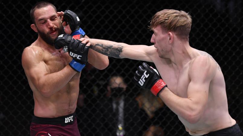 Kyle Daukaus punches Dustin Stoltzfus in their middleweight bout during the UFC 255 event at UFC APEX on November 21, 2020 in Las Vegas, Nevada. (Photo by Jeff Bottari/Zuffa LLC)