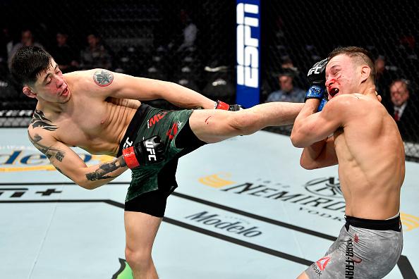 Brandon Moreno of Mexico kicks Kai Kara-France of New Zealand in their flyweight bout during the UFC 245 event at T-Mobile Arena on December 14, 2019 in Las Vegas, Nevada. (Photo by Jeff Bottari/Zuffa LLC)