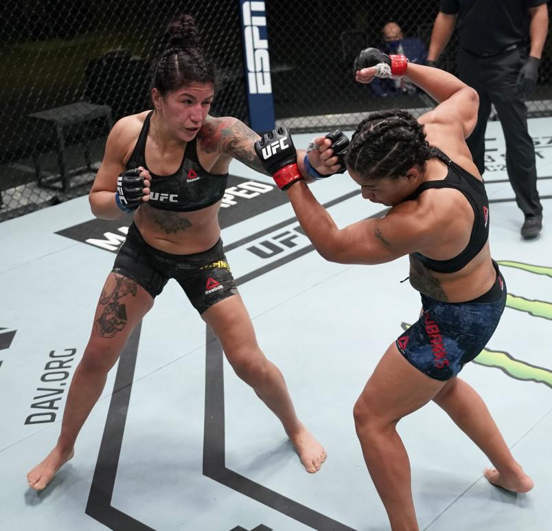 Pannie Kianzad of Iran punches Sijara Eubanks in a bantamweight fight during the UFC Fight Night event at UFC APEX on December 19, 2020 in Las Vegas, Nevada. (Photo by Cooper Neill/Zuffa LLC via Getty Images)