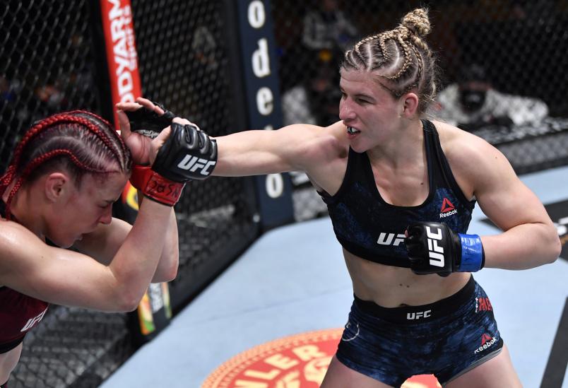 Miranda Maverick punches Gillian Robertson of Canada in their lightweight fight during the UFC 260 event at UFC APEX on March 27, 2021 in Las Vegas, Nevada. (Photo by Jeff Bottari/Zuffa LLC)