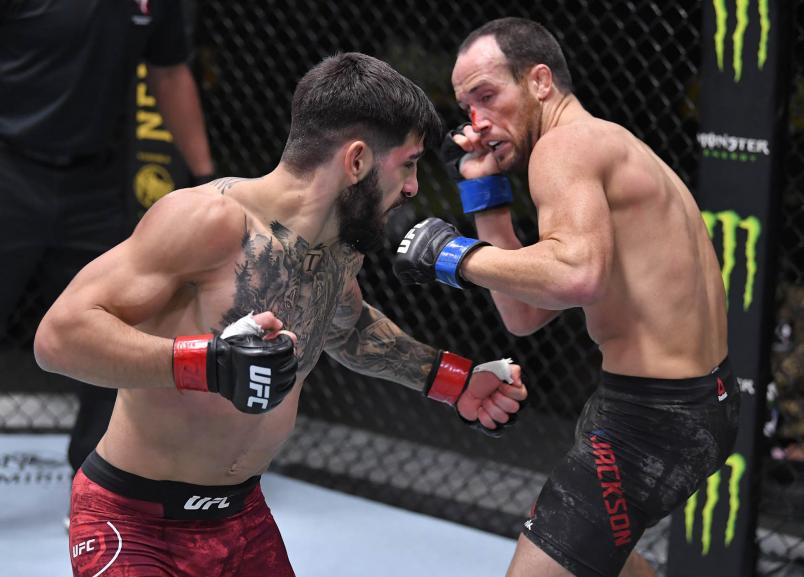 Ilia Topuria of Germany punches Damon Jackson in a featherweight bout during the UFC Fight Night event at UFC APEX on December 05 2020 in Las Vegas Nevada. (Photo by Chris Unger/Zuffa LLC)