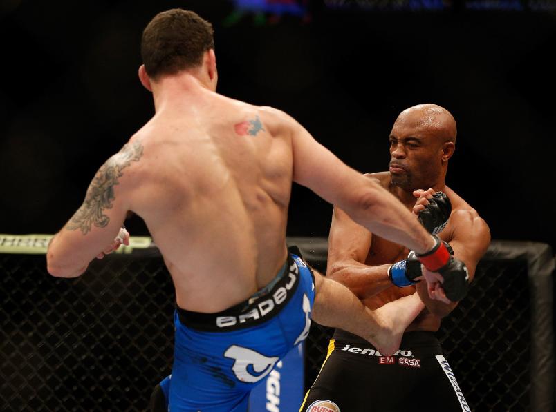 Chris Weidman kicks Anderson Silva in their UFC middleweight championship bout during the UFC 168 event at the MGM Grand Garden Arena on December 28, 2013 in Las Vegas, Nevada. (Photo by Josh Hedges/Zuffa LLC)