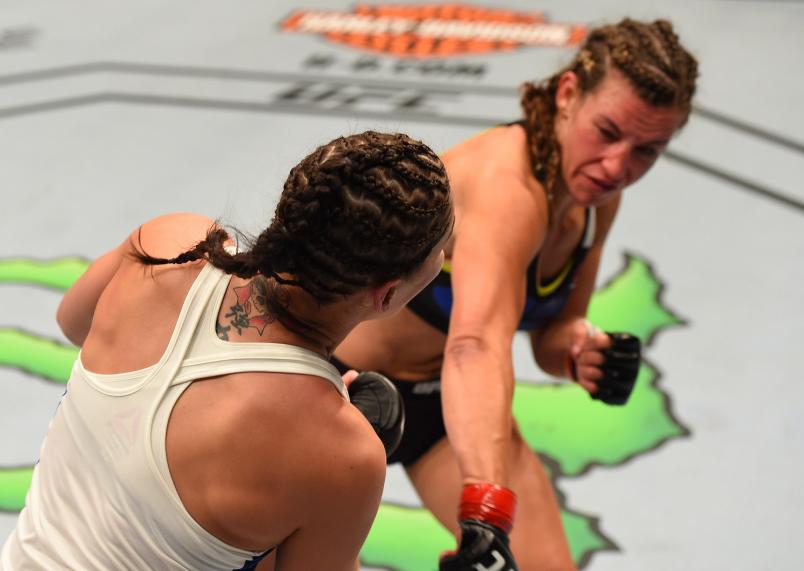 Miesha Tate drops Jessica Eye with a punch in their women's bantamweight bout during the UFC event at the United Center on July 25, 2015 in Chicago, Illinois. (Photo by Jeff Bottari/Zuffa LLC)