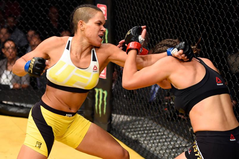 Amanda Nunes of Brazil punches Miesha Tate in their UFC women's bantamweight championship bout during the UFC 200 event at T-Mobile Arena on July 9, 2016 in Las Vegas, Nevada. (Photo by Josh Hedges/Zuffa LLC)