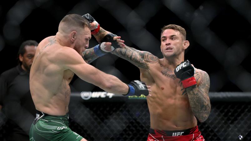 Dustin Poirier (R) lands a punch on Conor McGregor of Ireland in the first round in their lightweight bout during UFC 264: Poirier v McGregor 3 at T-Mobile Arena on July 10, 2021 in Las Vegas, Nevada. (Photo by Stacy Revere/Getty Images)