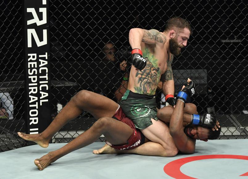 Michael Chiesa punches Neil Magny in a welterweight fight during the UFC Fight Night event at Etihad Arena on UFC Fight Island on January 20 2021 in Abu Dhabi United Arab Emirates. (Photo by Jeff Bottari/Zuffa LLC)