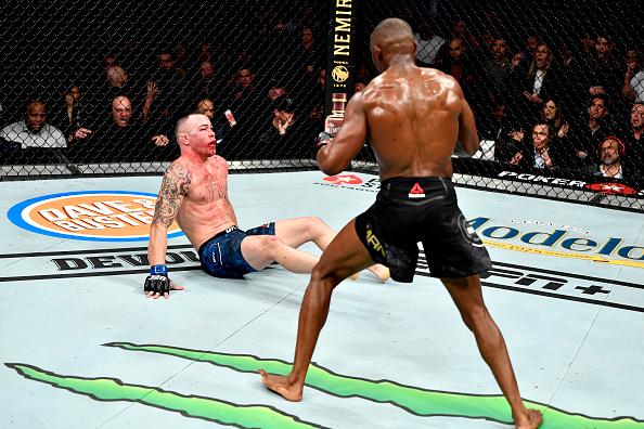Kamaru Usman of Nigeria knocks down Colby Covington in their UFC welterweight championship bout during the UFC 245 event at T-Mobile Arena on December 14, 2019 in Las Vegas, Nevada. (Photo by Jeff Bottari/Zuffa LLC)
