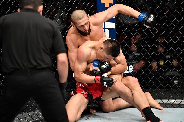 Khamzat Chimaev of Sweden punches Li Jingliang of China in a welterweight fight during the UFC 267 event at Etihad Arena on October 30, 2021 in Yas Island, Abu Dhabi, United Arab Emirates. (Photo by Chris Unger/Zuffa LLC)