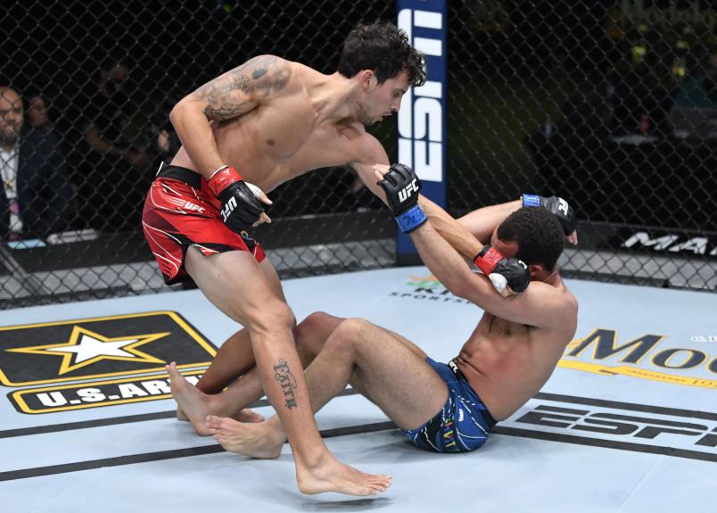 Claudio Puelles of Peru punches Jordan Leavitt in a lightweight fight during the UFC Fight Night event at UFC APEX on June 05, 2021 in Las Vegas, Nevada. (Photo by Jeff Bottari/Zuffa LLC via Getty Images)
