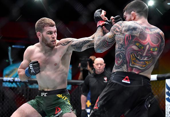 Jake Matthews of Australia punches Sean Brady in their welterweight fight during the UFC 259 event at UFC APEX on March 06, 2021 in Las Vegas, Nevada. (Photo by Chris Unger/Zuffa LLC)