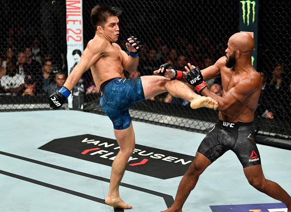 Henry Cejudo kicks Demetrious Johnson in their UFC flyweight championship fight during the UFC 227 event inside Staples Center on August 4, 2018 in Los Angeles, California. (Photo by Jeff Bottari/Zuffa LLC)