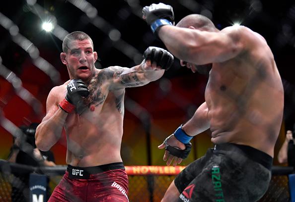 Marc-Andre Barriault of Canada punches Abu Azaitar of Morocco in their middleweight fight during the UFC 260 event at UFC APEX on March 27, 2021 in Las Vegas, Nevada. (Photo by Chris Unger/Zuffa LLC)