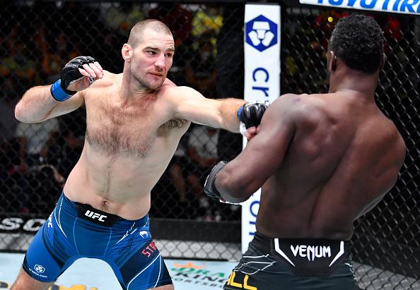 Sean Strickland punches Uriah Hall of Jamaica in a middleweight fight during the UFC Fight Night event at UFC APEX on July 31, 2021 in Las Vegas, Nevada.