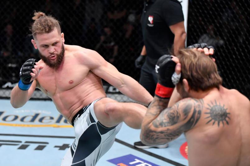 Rafael Fiziev of Kyrgyzstan kicks Brad Riddell of New Zealand in their lightweight fight during the UFC Fight Night event at UFC APEX on December 04, 2021 in Las Vegas, Nevada. (Photo by Jeff Bottari/Zuffa LLC)