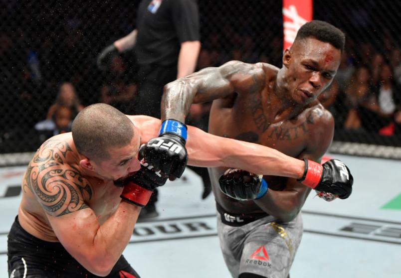 Robert Whittaker of New Zealand and Israel Adesanya of Nigeria trade punches in their UFC middleweight championship fight during the UFC 243 event at Marvel Stadium on October 06, 2019 in Melbourne, Australia. (Photo by Jeff Bottari/Zuffa LLC/Zuffa LLC via Getty Images)