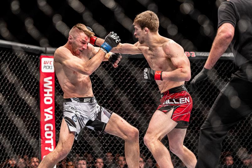 LONDON, ENGLAND - MARCH 19: (R-L) Arnold Allen punches Dan Hooker at O2 Arena on March 19, 2022 in London, England. (Photo by John Barry/Zuffa LLC)