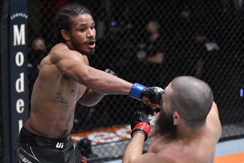 Darian Weeks punches Bryan Barberena in their welterweight fight during the UFC Fight Night event at UFC APEX on December 04, 2021 in Las Vegas, Nevada. (Photo by Jeff Bottari/Zuffa LLC)