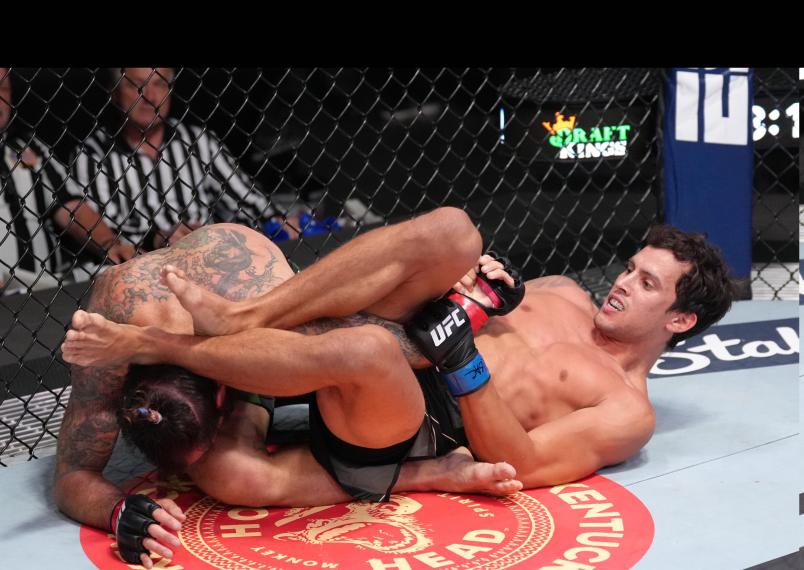Claudio Puelles of Peru works for a submission against Clay Guida in a lightweight fight during the UFC Fight Night event at UFC APEX on April 23, 2022 in Las Vegas, Nevada. (Photo by Jeff Bottari/Zuffa LLC)