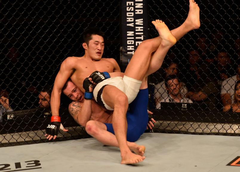 Colby Covington takes down Dong Hyun Kim of South Korea in their welterweight bout during the UFC Fight Night event at the Singapore Indoor Stadium on June 17, 2017 in Singapore. (Photo by Brandon Magnus/Zuffa LLC/Zuffa LLC via Getty Images)