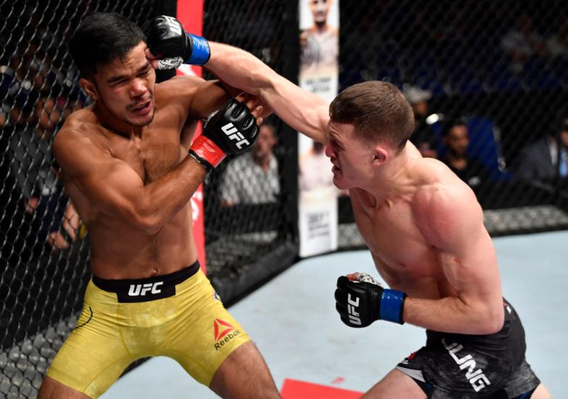 Shane Young of New Zealand punches Rolando Dy of Phillippines in their featherweight bout during the UFC Fight Night event at the Singapore Indoor Stadium on June 23, 2018 in Singapore. (Photo by Jeff Bottari/Zuffa LLC/Zuffa LLC via Getty Images)