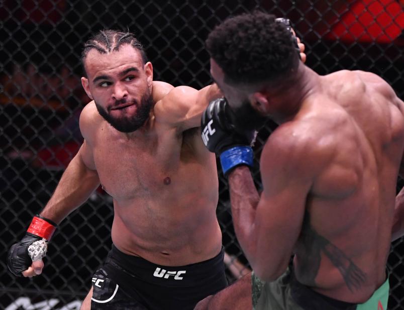 Gabe Green punches Phil Rowe in their welterweight fight during the UFC 258 event at UFC APEX on February 13, 2021 in Las Vegas, Nevada. (Photo by Jeff Bottari/Zuffa LLC)