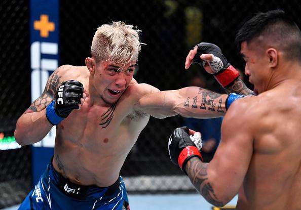 TJ Brown punches Kai Kamaka in a featherweight bout during the UFC Fight Night event at UFC APEX on May 01, 2021 in Las Vegas, Nevada. (Photo by Jeff Bottari/Zuffa LLC)