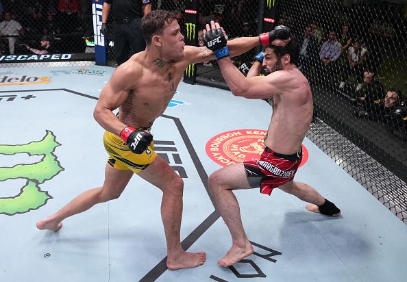 Caio Borralho of Brazil punches Gadzhi Omargadzhiev of Russia in a middleweight fight during the UFC Fight Night event at UFC APEX on April 16, 2022 in Las Vegas, Nevada. (Photo by Jeff Bottari/Zuffa LLC)