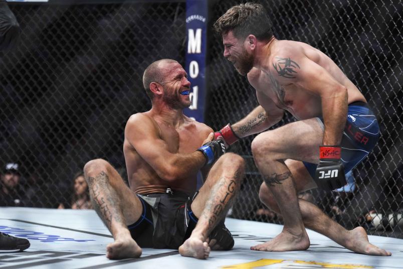 Donald Cerrone and Jim Miller talk after the conclusion of the round in a welterweight fight during the UFC 276 event