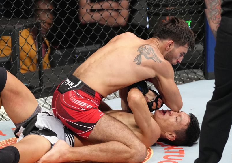 Matt Schnell elbows Sumudaerji of China in a flyweight fight during the UFC Fight Night event at UBS Arena on July 16, 2022 in Elmont, New York. (Photo by Jeff Bottari/Zuffa LLC)