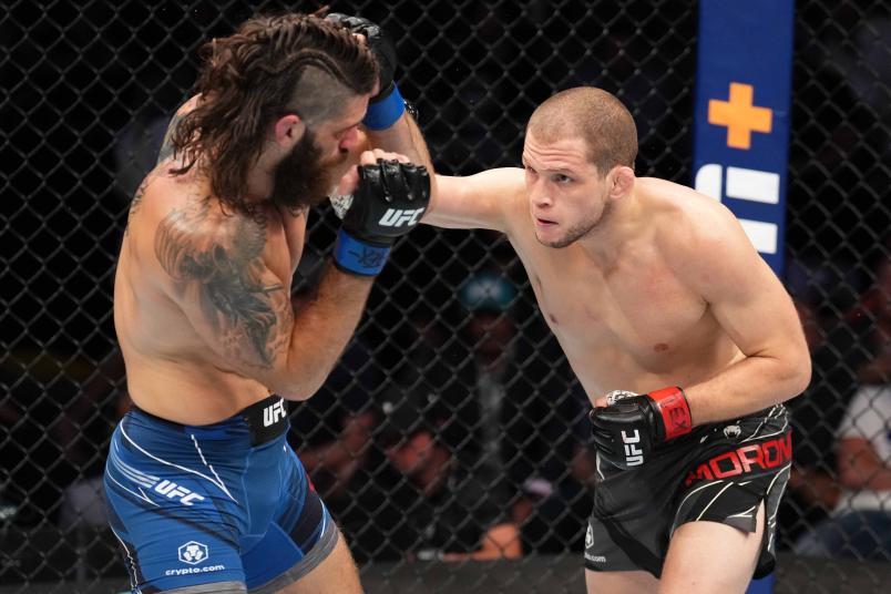 Alex Morono punches Matthew Semelsberger in a welterweight fight during the UFC 277 event