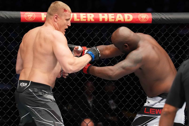 Sergei Pavlovich of Russia punches Derrick Lewis in a heavyweight fight during the UFC 277 event