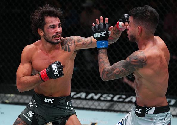 Alexandre Pantoja of Brazil punches Brandon Royval in a flyweight fight during the UFC Fight Night event at UFC APEX on August 21, 2021 in Las Vegas, Nevada. (Photo by Chris Unger/Zuffa LLC)