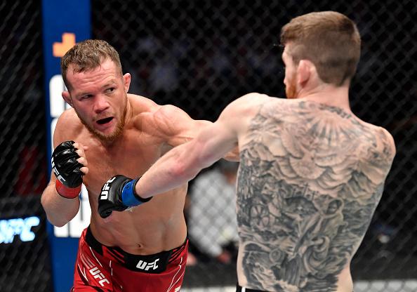 Petr Yan of Russia punches Cory Sandhagen in the UFC interim bantamweight championship fight during the UFC 267 event at Etihad Arena on October 30, 2021 in Yas Island, Abu Dhabi, United Arab Emirates. (Photo by Chris Unger/Zuffa LLC)